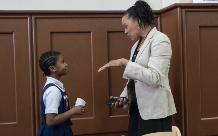 Dawn Staley talks to young African American girl