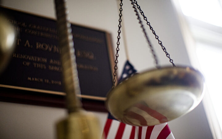 scales of justice with American flag in the background