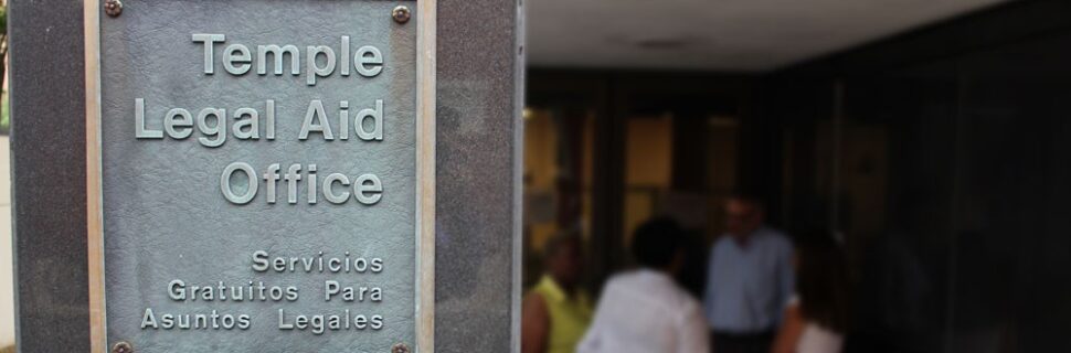 Legal aid sign with people in the background