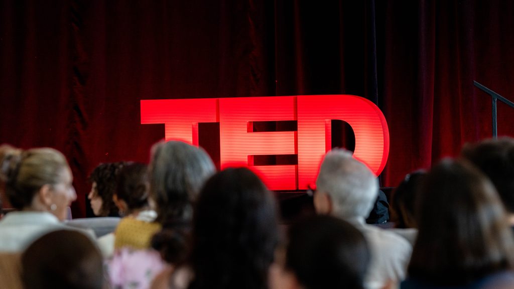 "TED" logo on stage, photo credit from https://www.visitphilly.com/ted/#ted-democracy